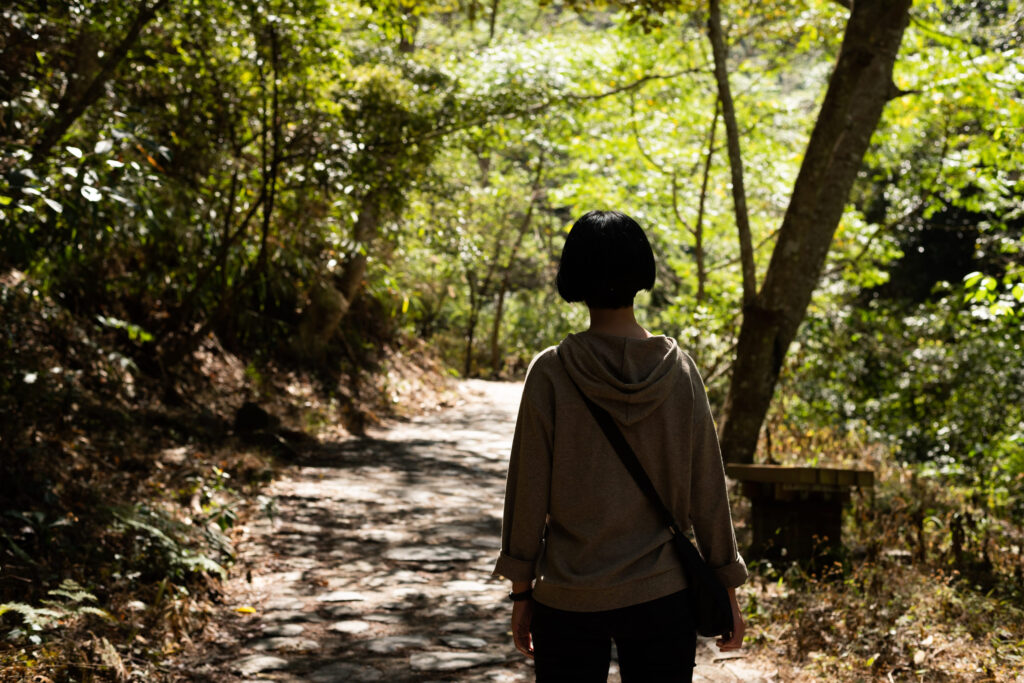 traveling Asian woman hiking at the outdoor in the forest