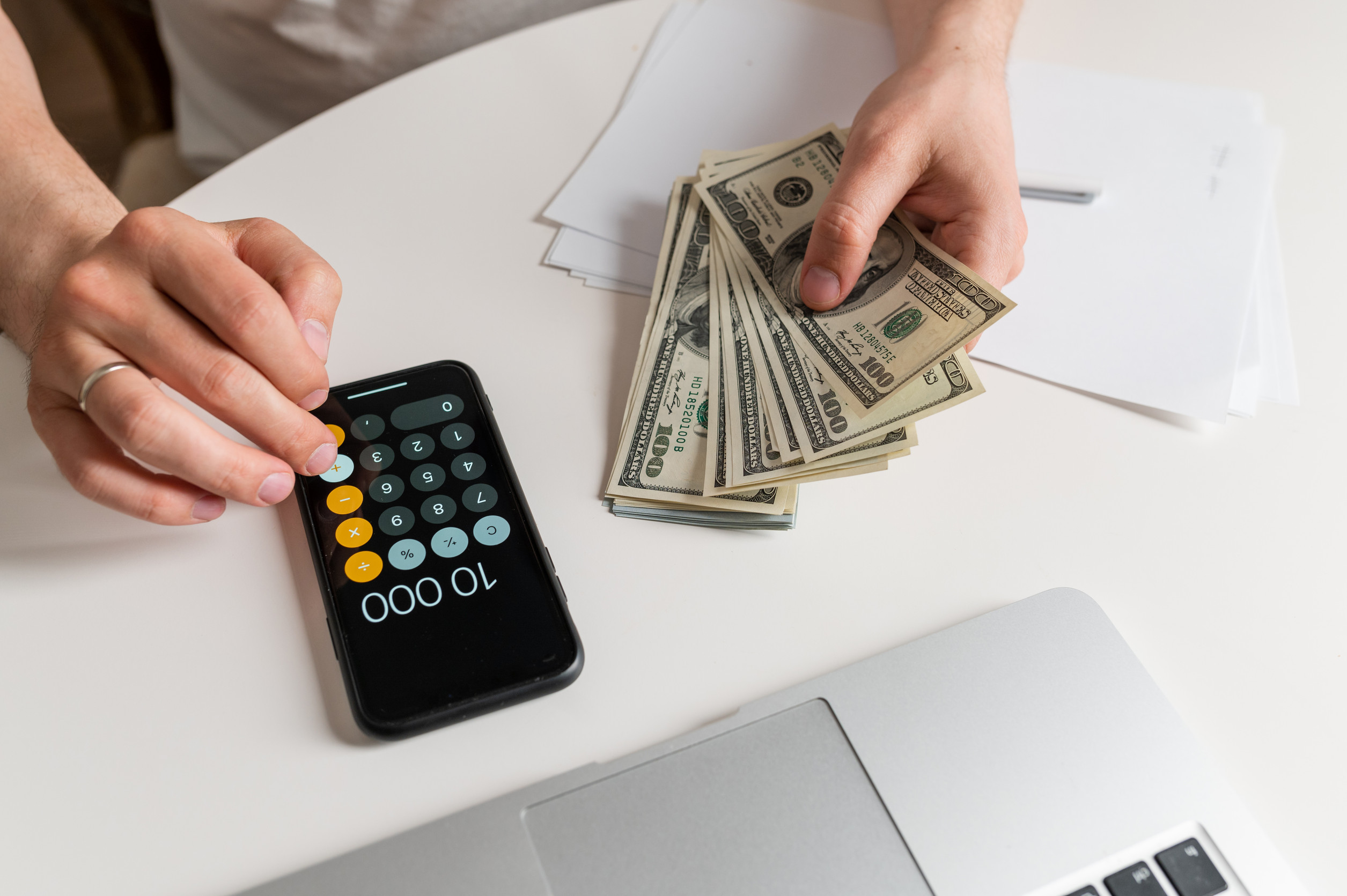 Business man counting money, saving money, and taking notes for the future And calculate income-expenses for the family, money-saving ideas and counting money