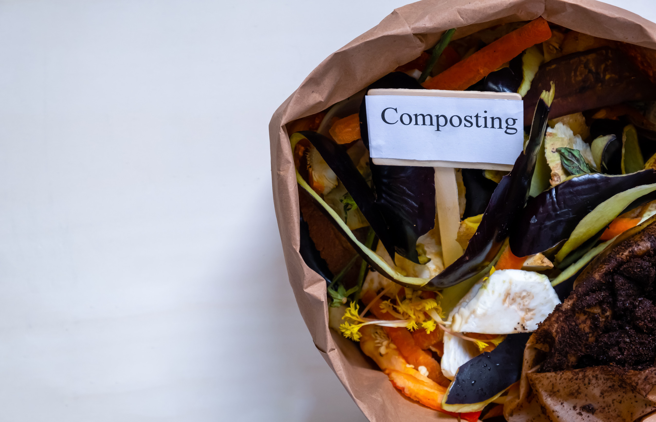 Organic food waste. Paper bag with vegetable leftovers for compost Top view. Recycle concept. Organic, waste-free lifestyle. Close up.