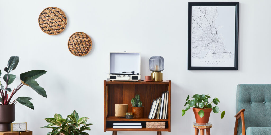  room interior with mock up poster map, wooden shelf, book, armchair, plant, cacti, vinyl recorder, decoration and personal accessories 