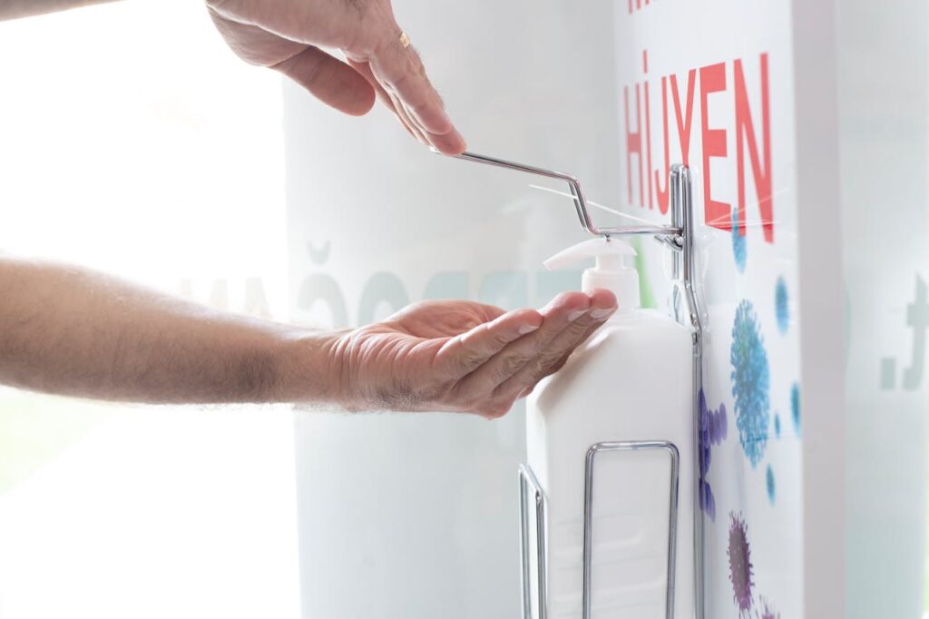 /person-holding-sanitizing-his-hands