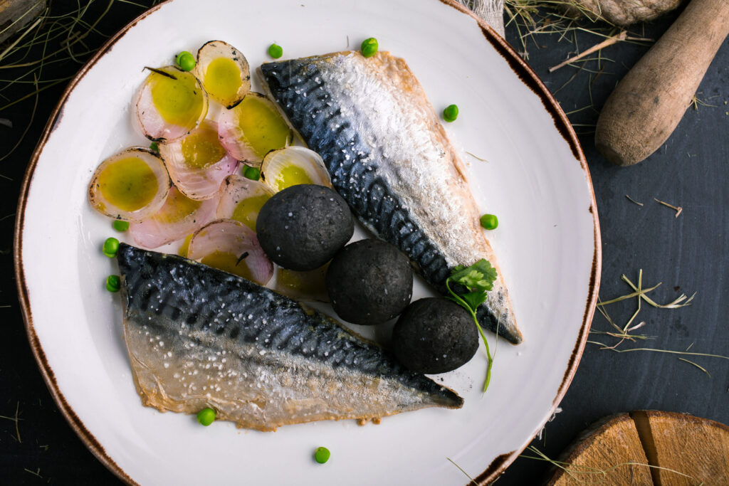 Restaurant dish with mackerel and onions