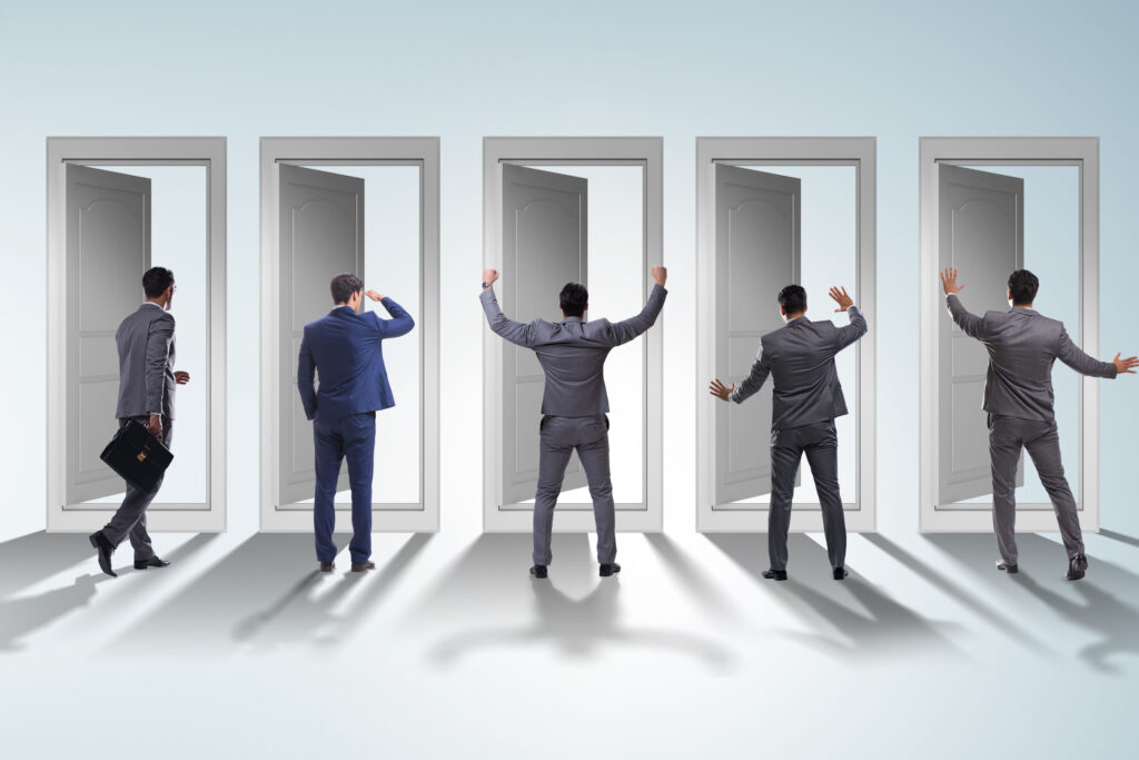 Businessman in uncertainty concept with many doors