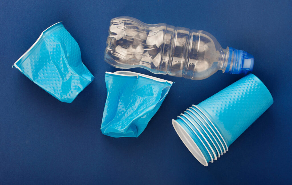 Plastic cups on a blue background. Colored