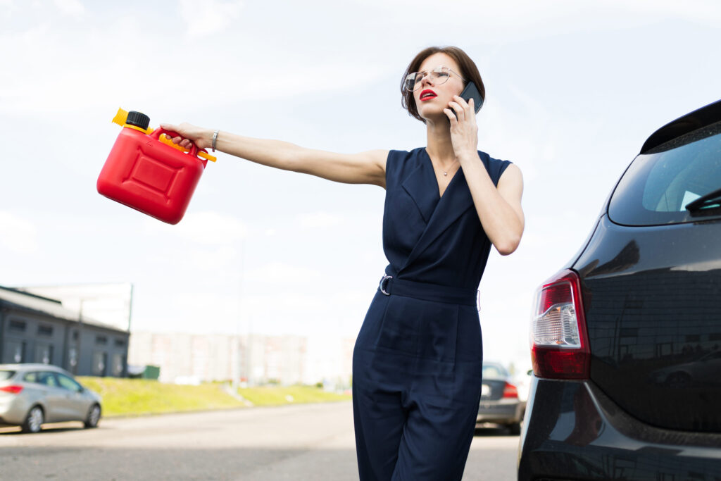 portrait of a girl on the background of a car with a canister in his hands, out of fuel in the car