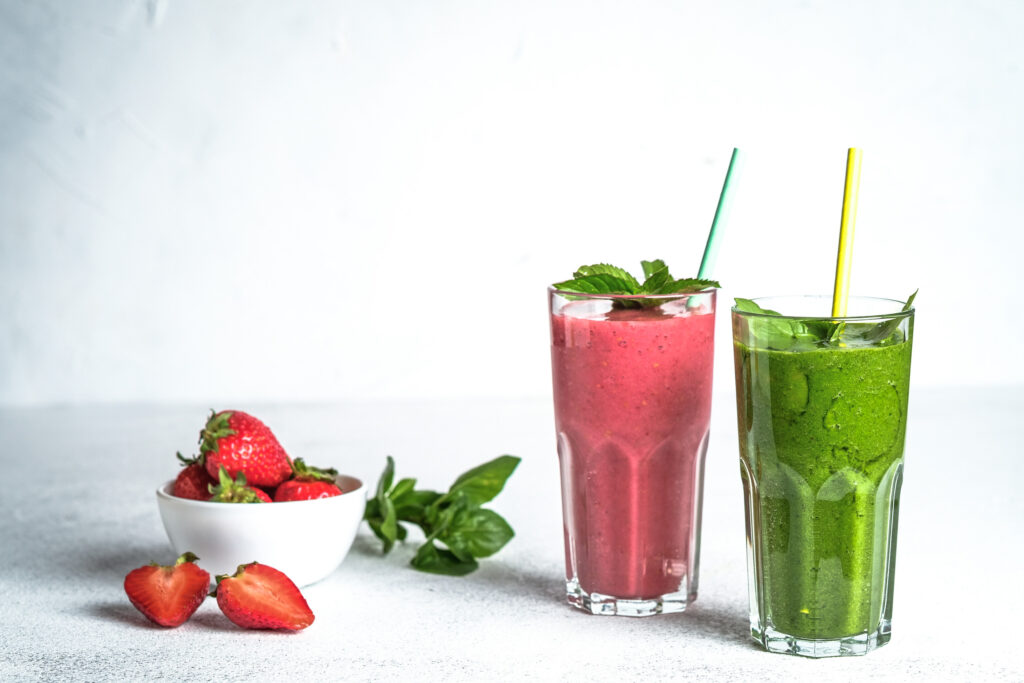 Organic berry and vegetable smoothie with oatmeal on a light background copy space. Healthy food. Lactose free diet.