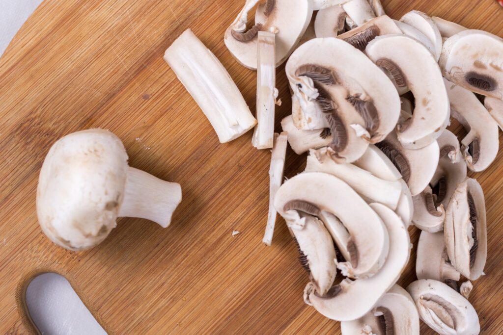 Sliced and chopped mushrooms on the cutting board