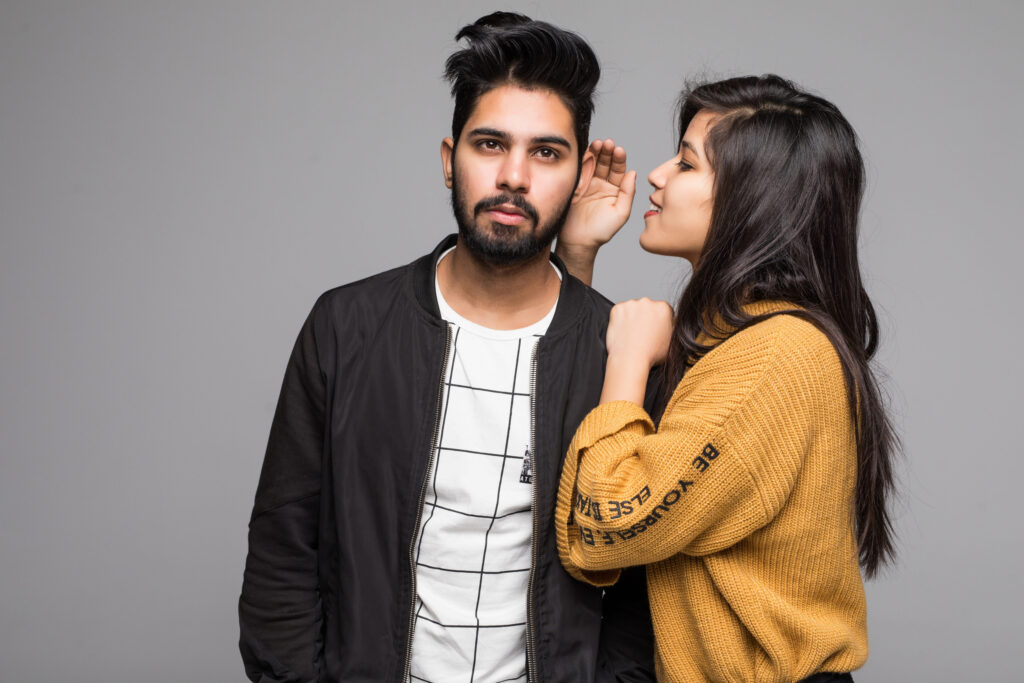 Young indian couple take selfie on green background