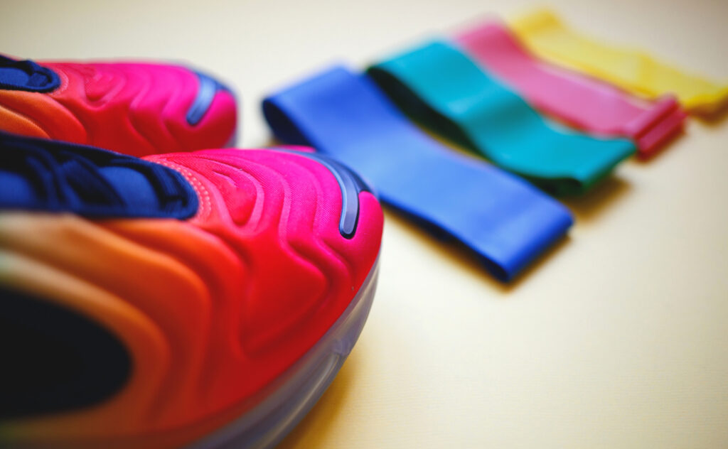 accessories for sports: sneakers and fitness elastic bands.