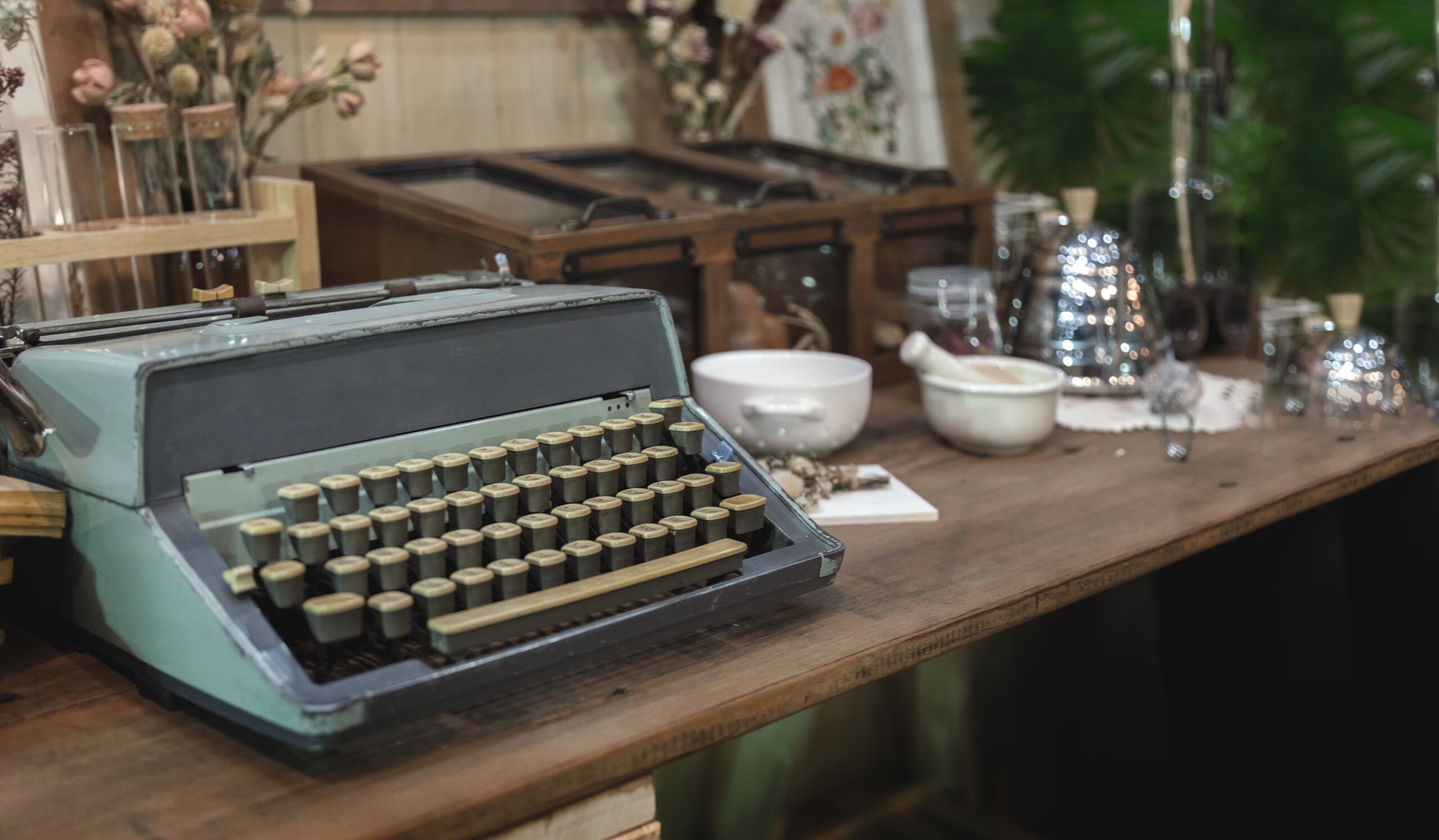 old typewriter on wood table in garden indoor in banner size background
