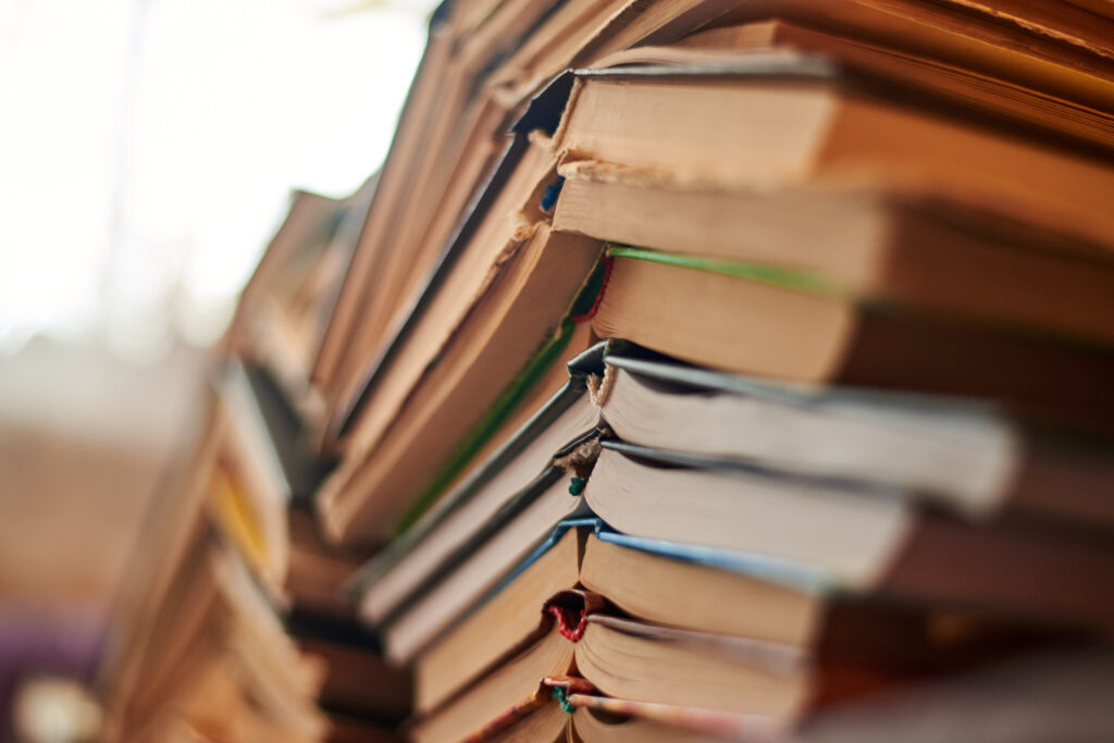 Old books piled up in a heap, close-up, selective focus, learning and education concept.