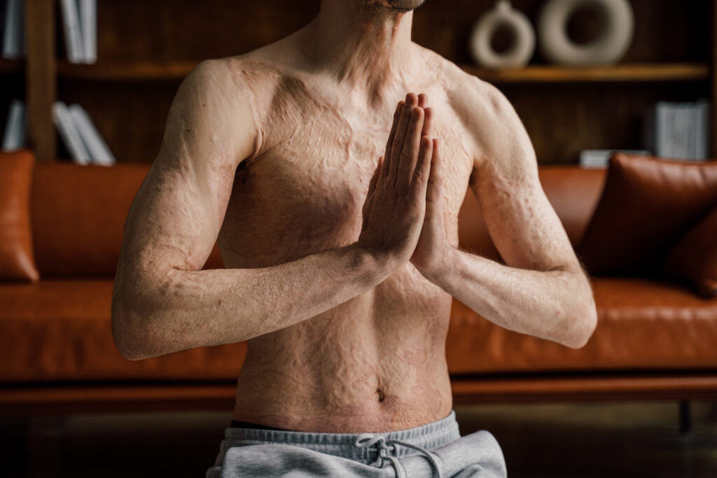 Man sitting at the living room and keeping hands in namaste gesture