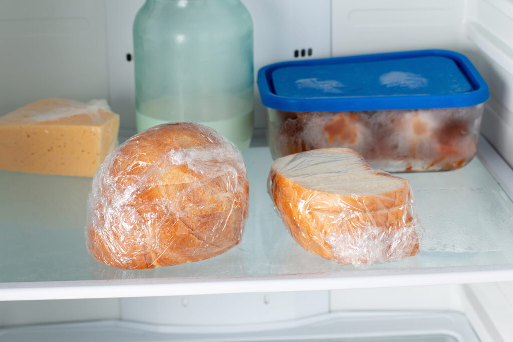 Frozen bread in the home refrigerator. The frozen products. Long life food storage concept.