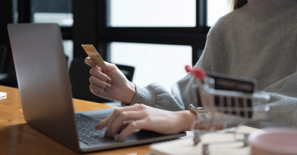 Close up of woman is hands holding cell telephone and credit card with blank copy space scree for your advertising text message or promotional content, shoping online.