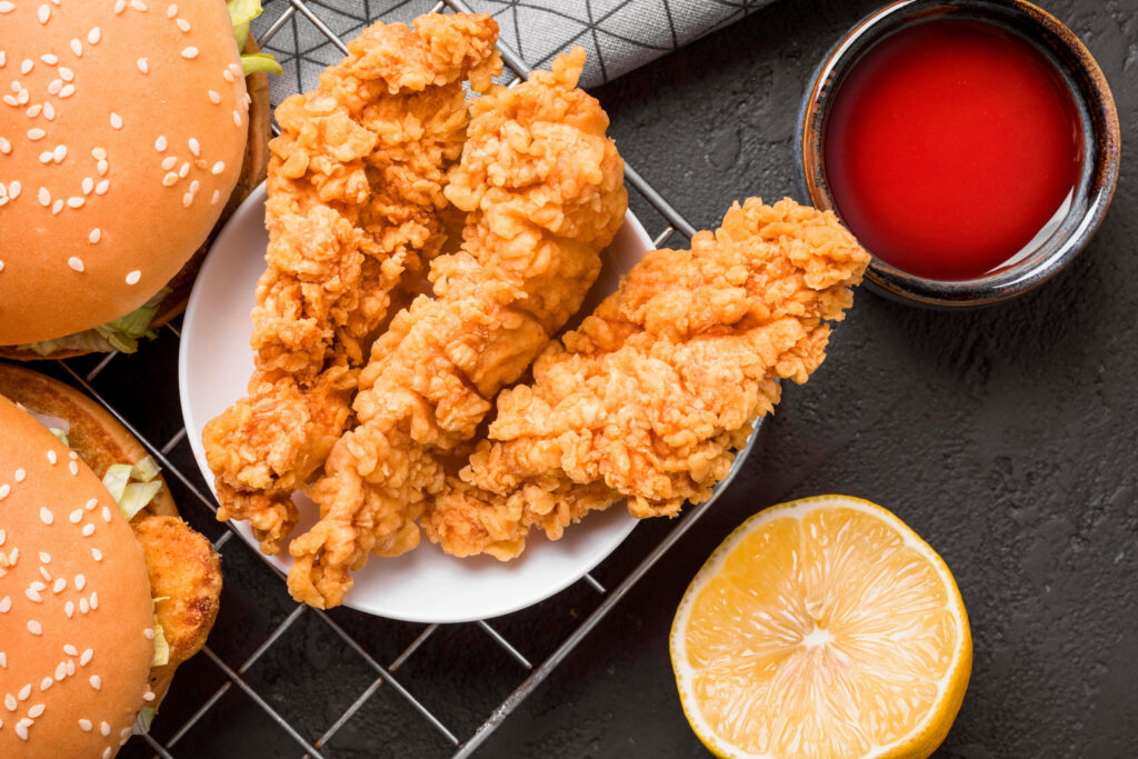 top view fried chicken burgers tray with sauce lemon