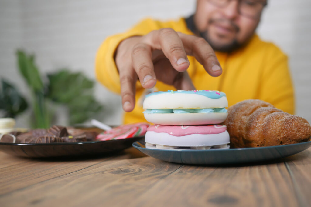 young man eating donut , selective focus