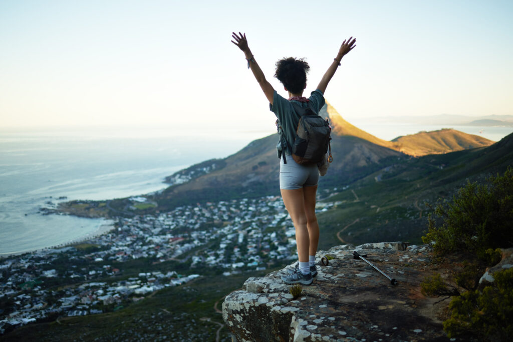 I made it all the way to the top. Shot of a woman standing with her arms outstretched while standing on a mountain cliff.