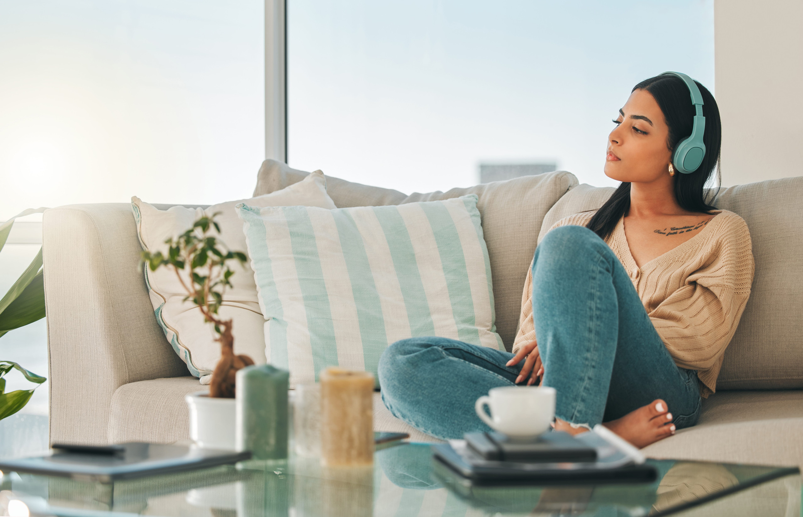 Chilling with some tunes. Shot of an attractive young woman listening to music while chilling at home.