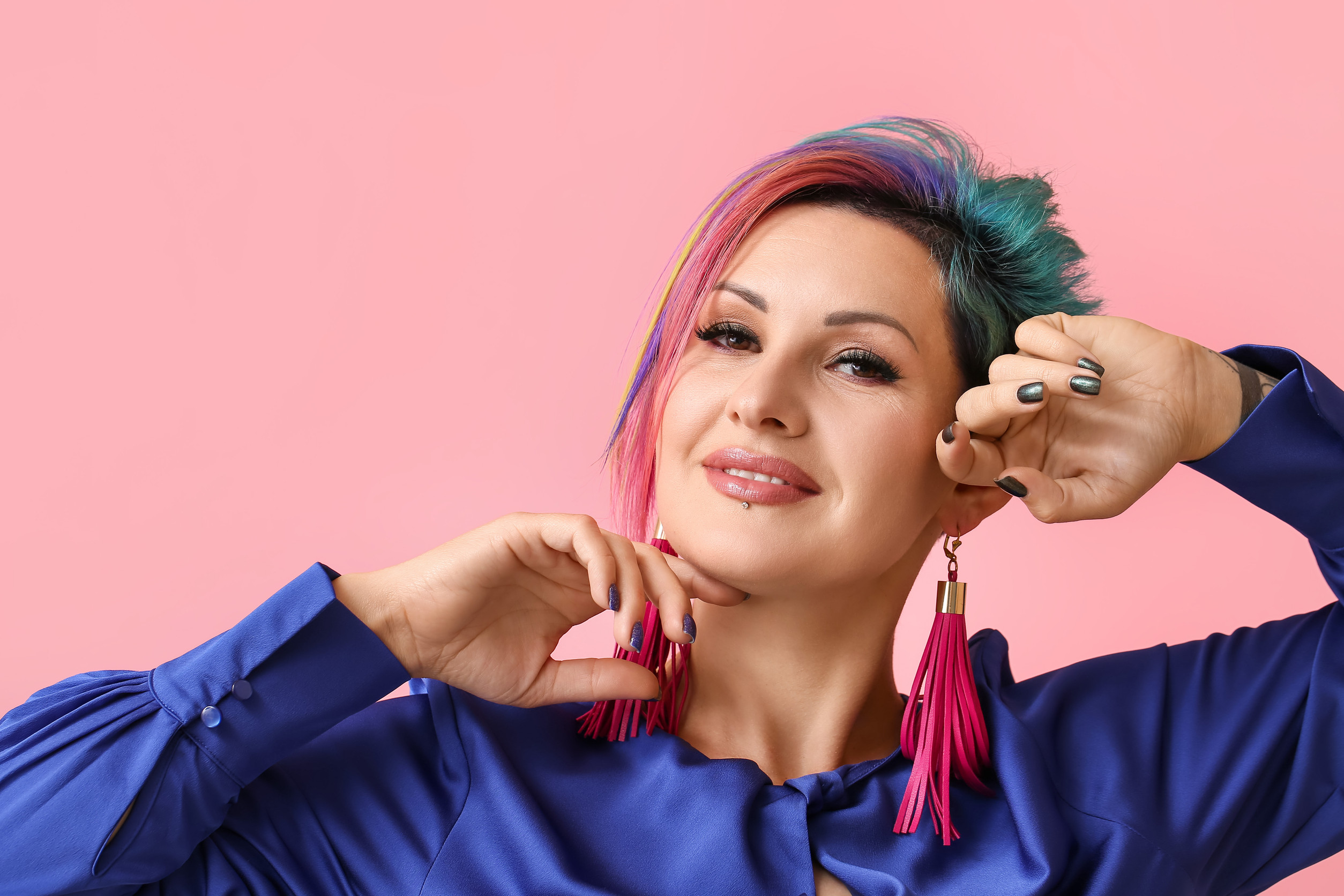 Beautiful woman with unusual hair on color background