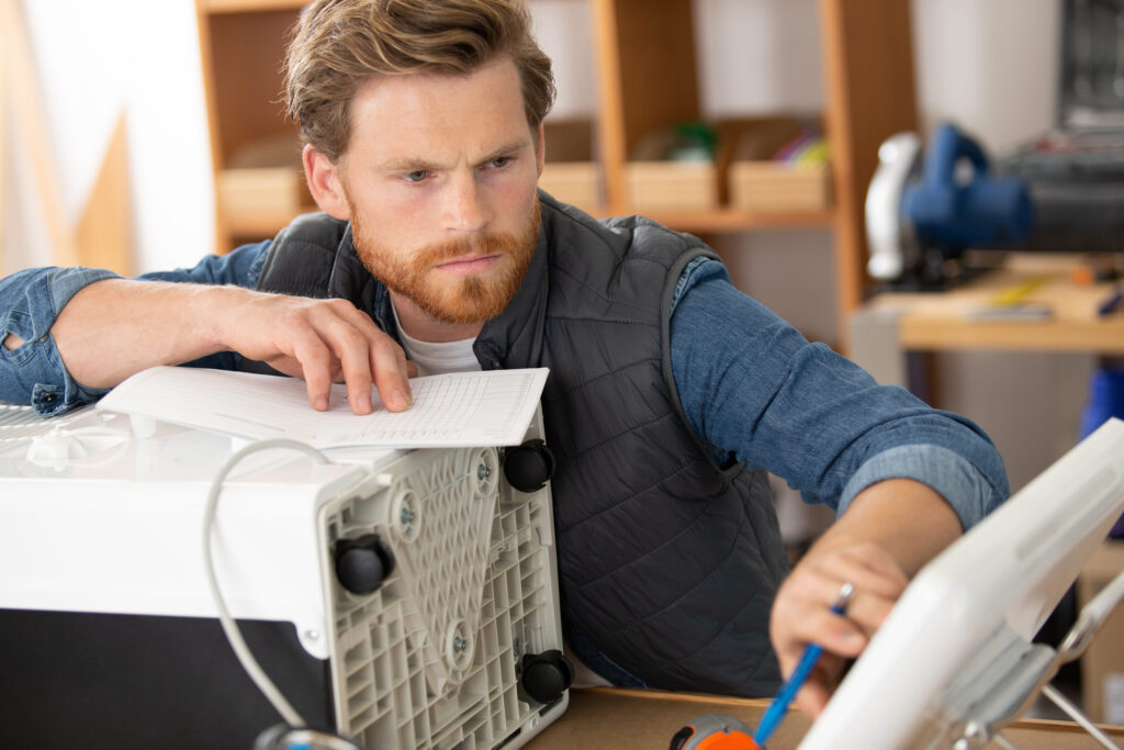 a professional electrician man is fixing the air conditioner