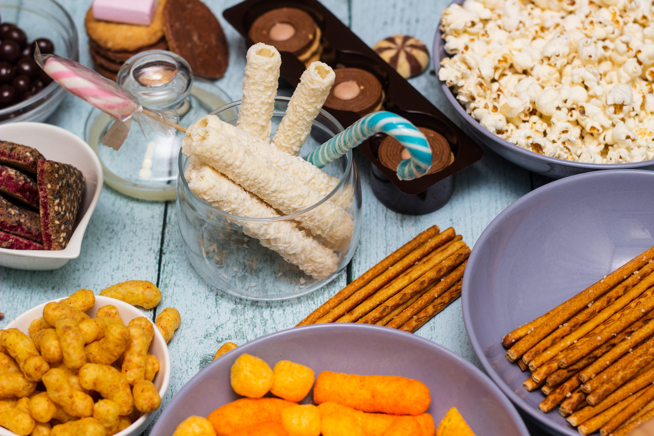 Table of salty and sweet snacks. Large group of unhealthy food