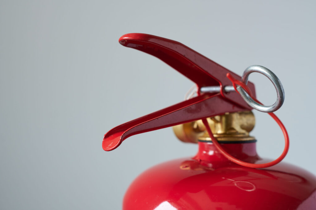 fire extinguisher on a gray background, close-up, macro