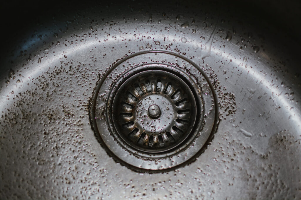 Coffee grounds poured into the kitchen sink. Do not throw the grounds into the sink, this can clog the drain.