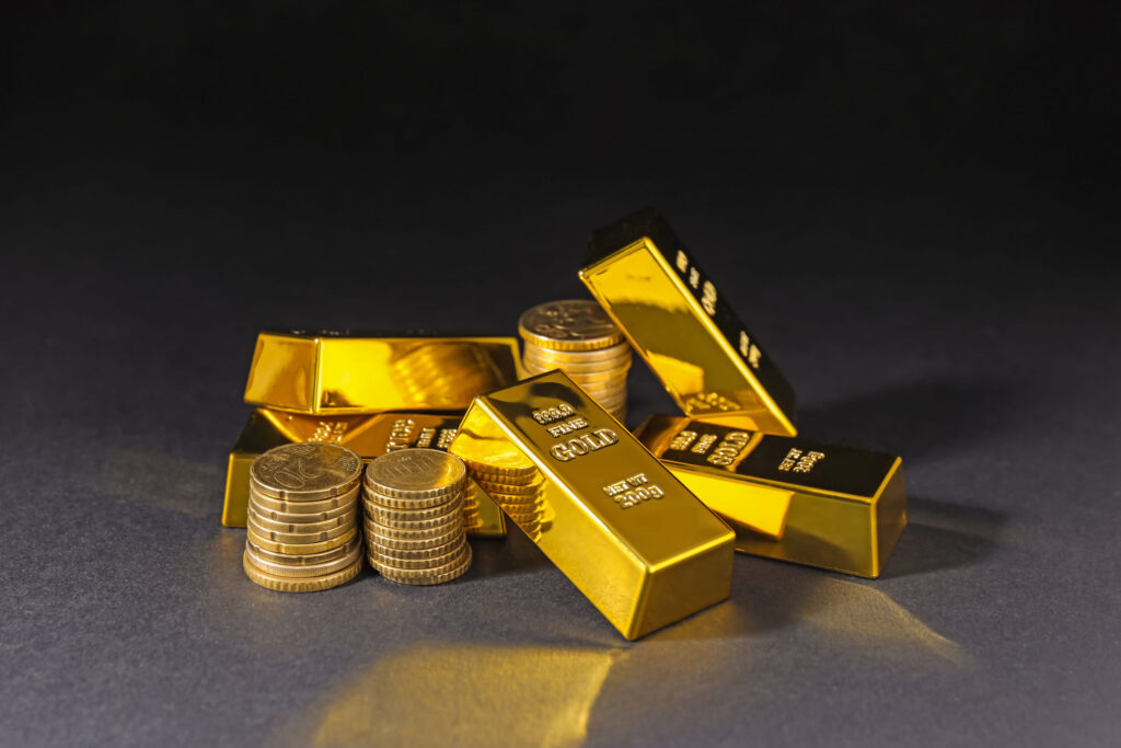 Gold bars and coins on black table