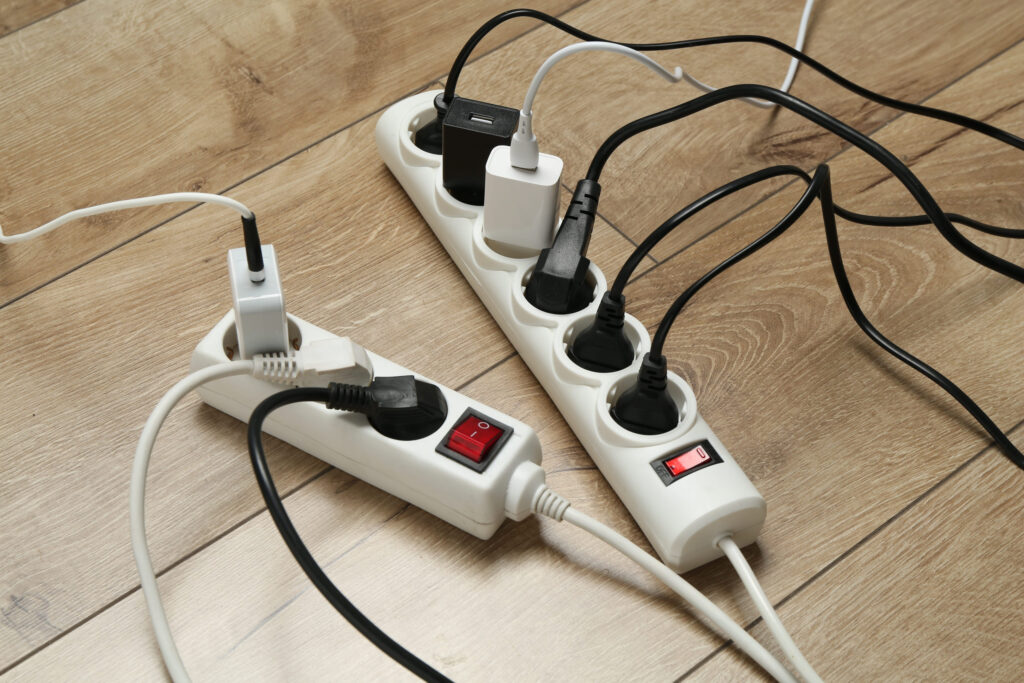 Extension power boards with plugs on wooden floor