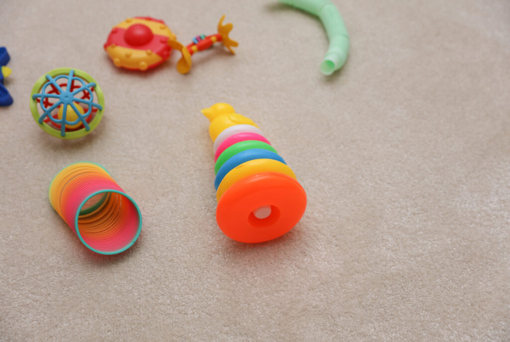 Lots of different toys for little children on the carpet