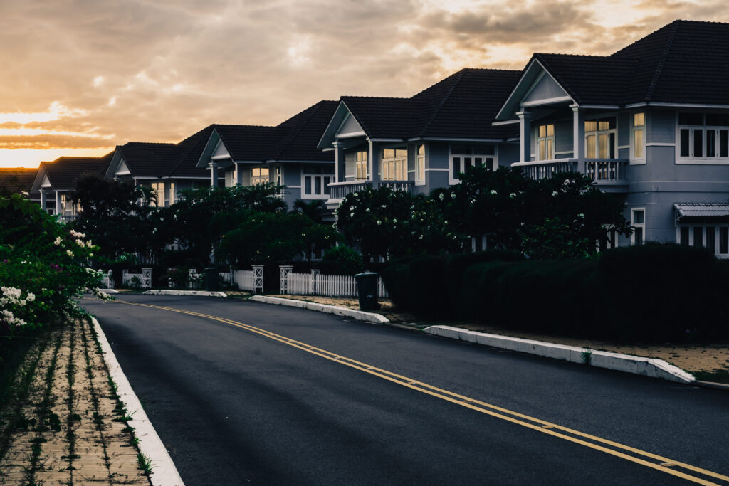 Modern cottages row road sidewalk two story buildings residential villas village New Estate Reflection dawn Sun in windows