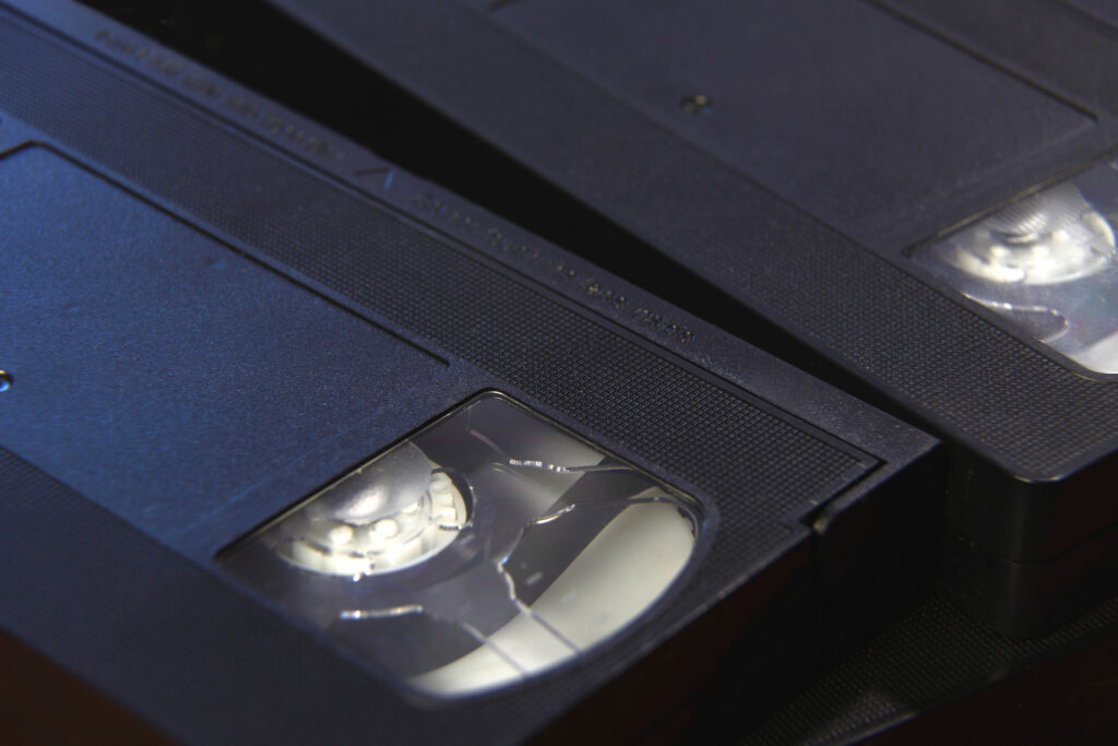 Stack of black VHS tape video cassettes close up