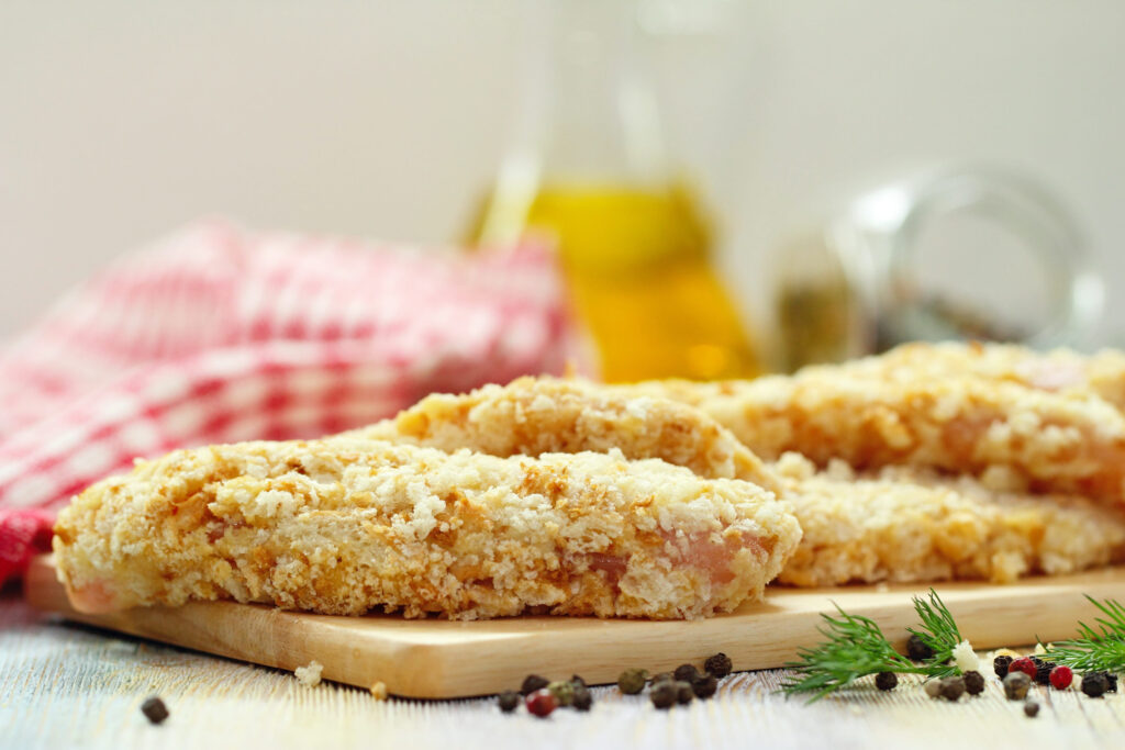 Raw chicken fillet in bread crumbs prepared for frying