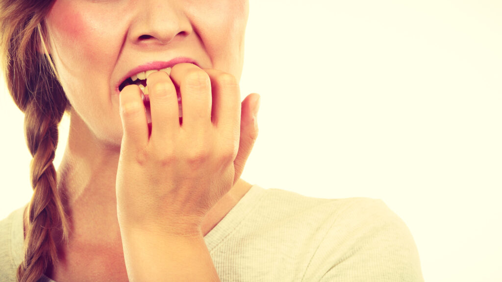 Stress, anxiety, emotions and problems concept. Scared, stressed woman biting her nails