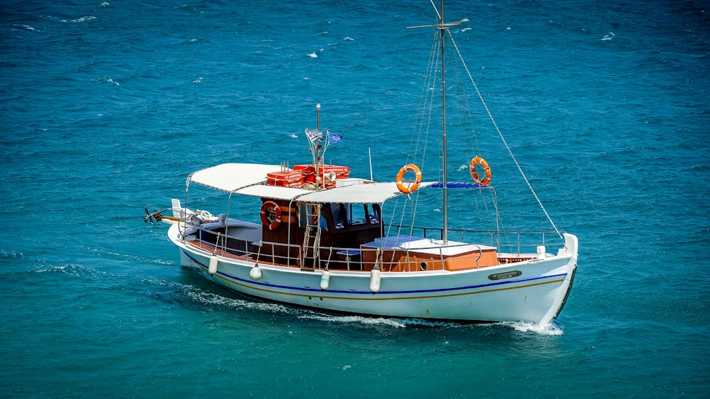A beautiful traditional boat cruising on the clear waters of the Mediterranean Sea.