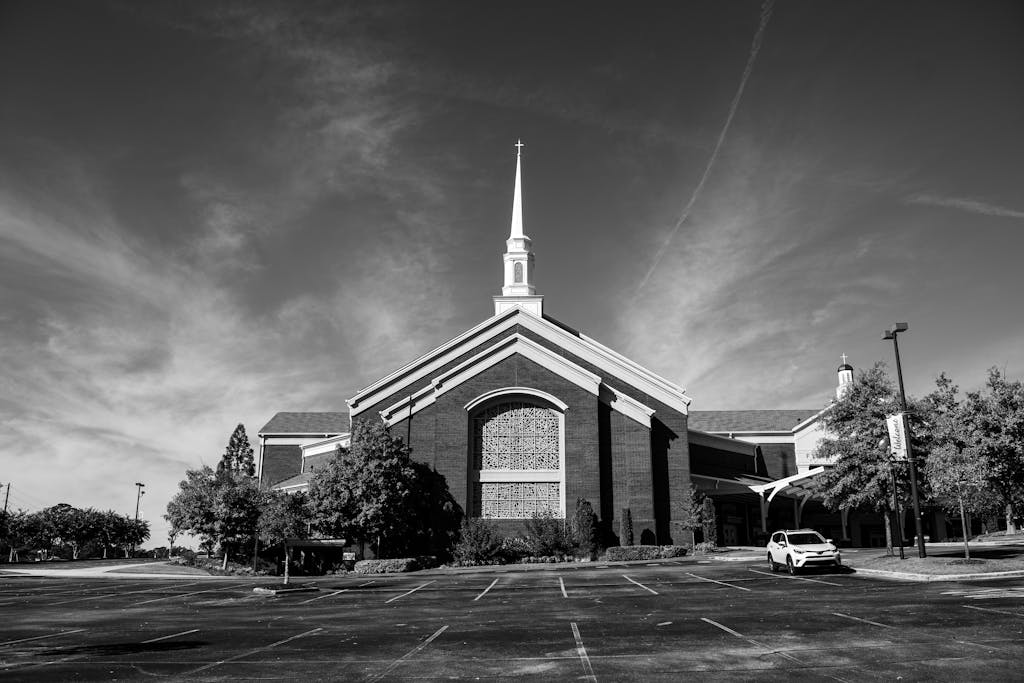 A black and white photo of a church in Trussville, Alabama, with a striking steeple.