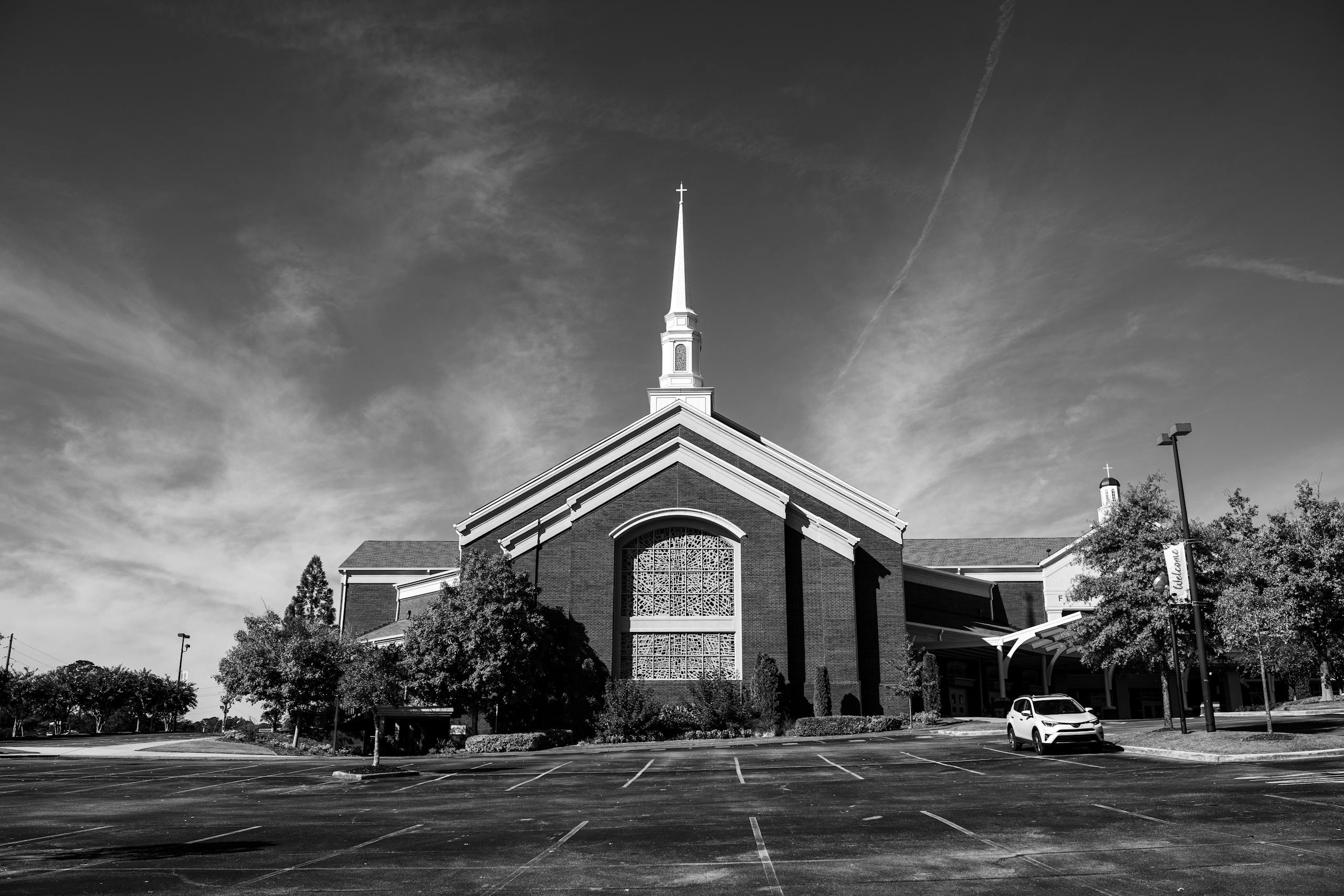 A black and white photo of a church in Trussville, Alabama, with a striking steeple.