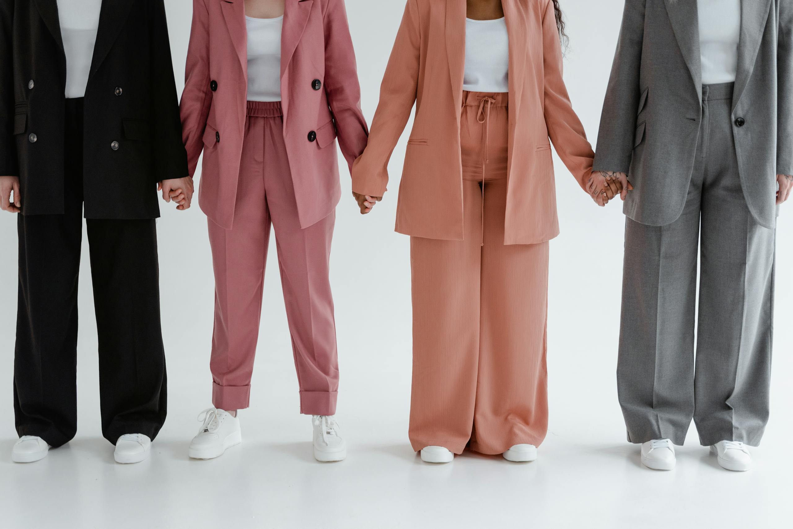 A diverse group standing together in stylish blazers, symbolizing unity and equality.