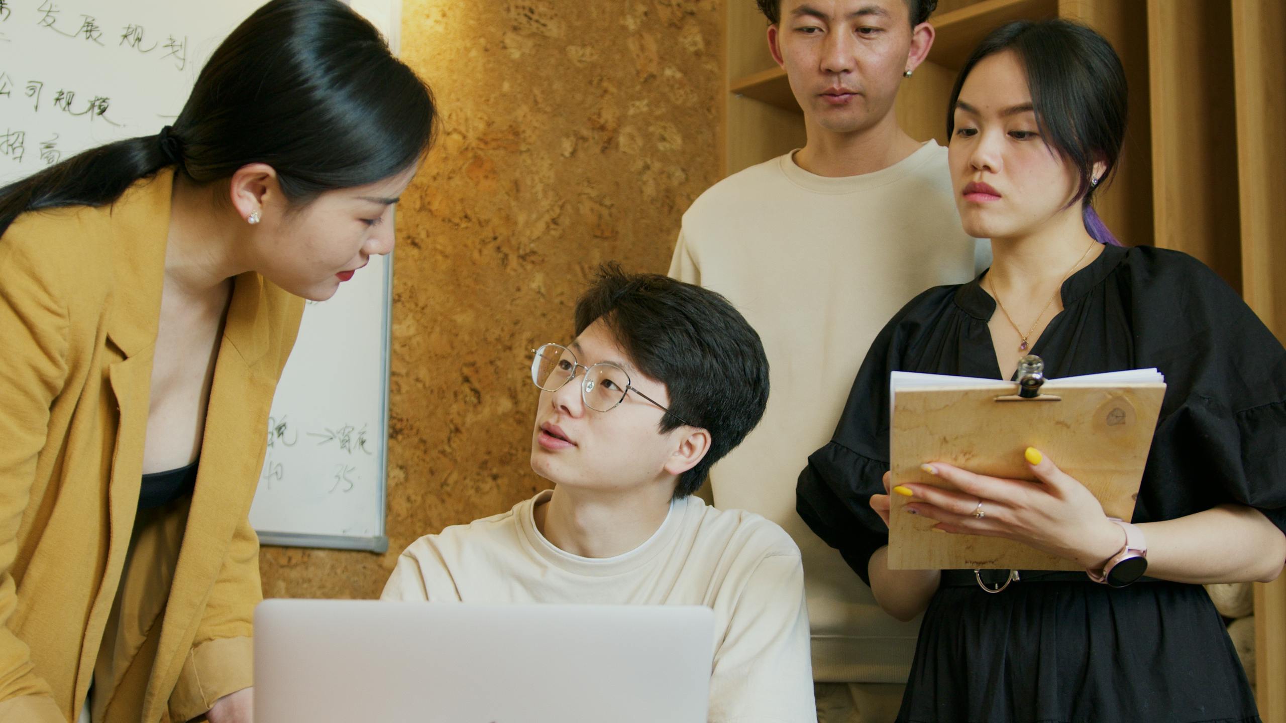 A group of professionals exchanging ideas during a business meeting indoors.