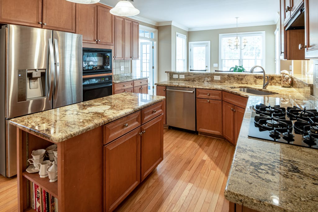 A luxurious kitchen interior featuring granite countertops and modern appliances.