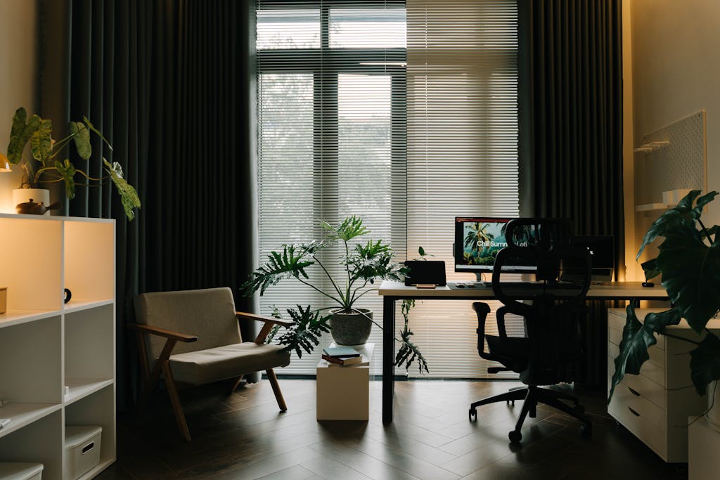 A stylish home office featuring indoor plants, natural light, and a modern workspace.