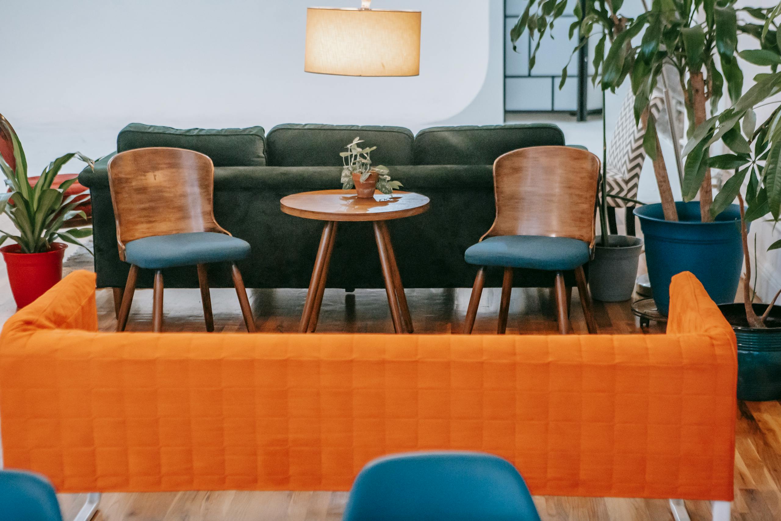 A stylish modern living room featuring wooden furniture and vibrant plants, creating a cozy ambiance.