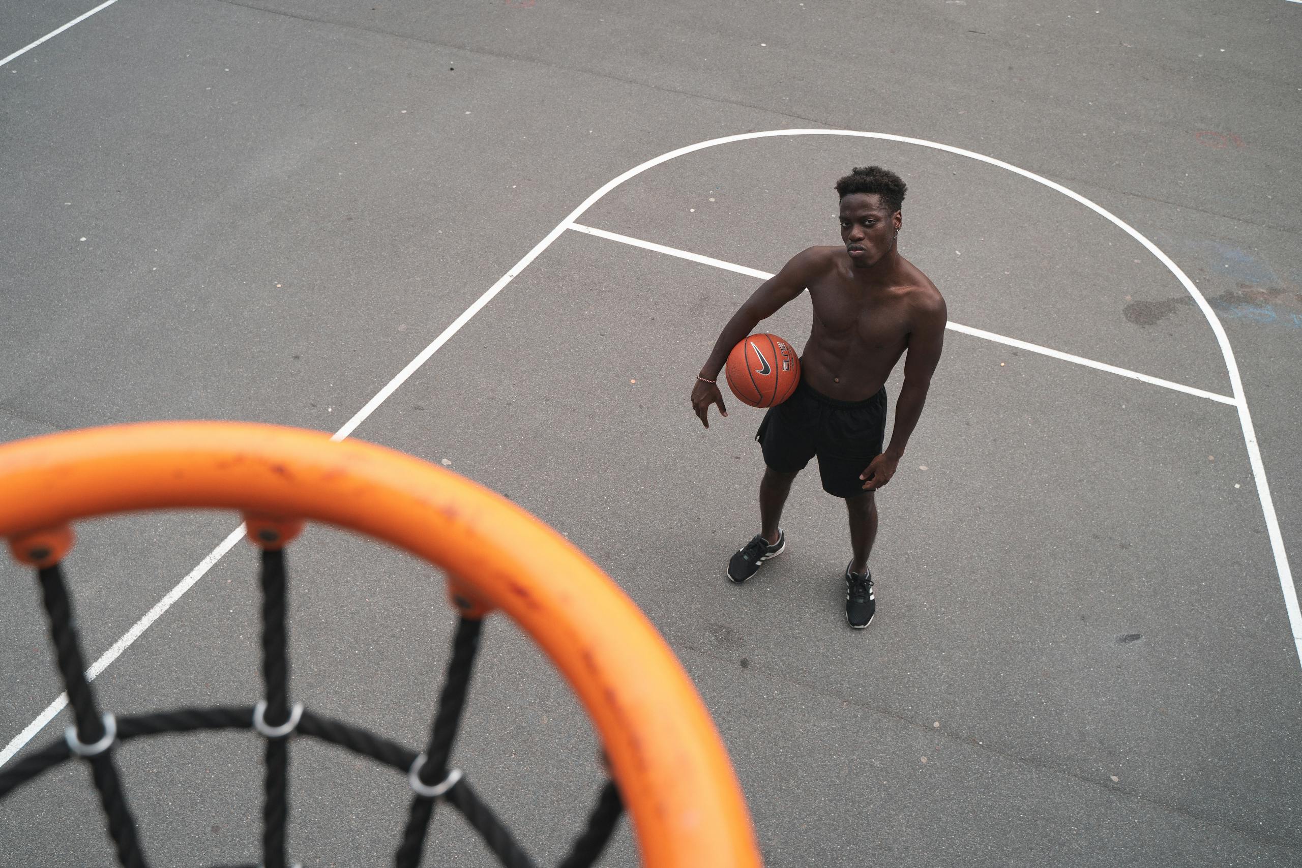 Aerial view of a basketball player holding a ball on an outdoor court.