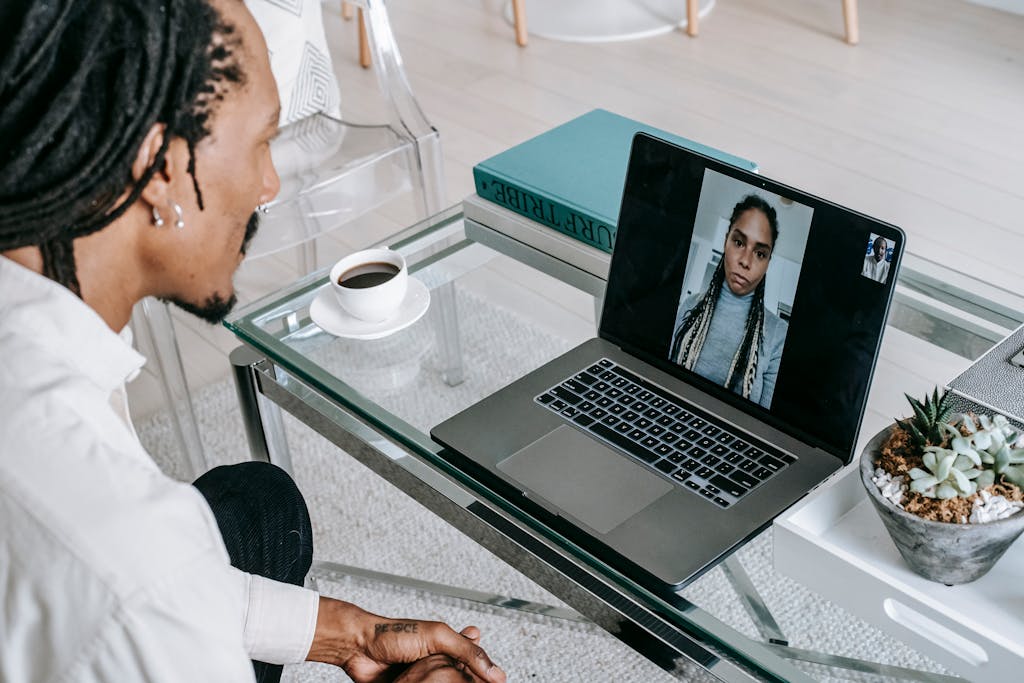 African American couple engaged in a video call, discussing something serious at home.