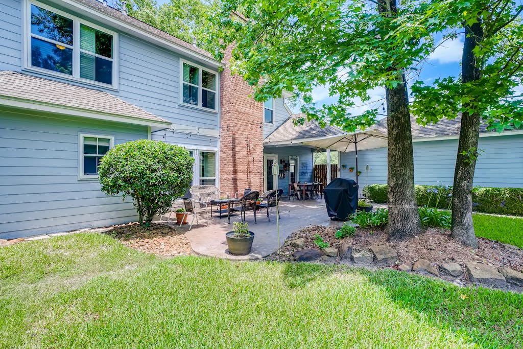 Beautiful residential backyard featuring a cozy patio and lush green surroundings.