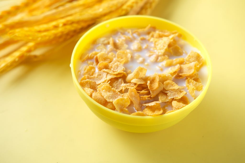 Bright cereal breakfast with milk in a yellow bowl, ideal for healthy starts.
