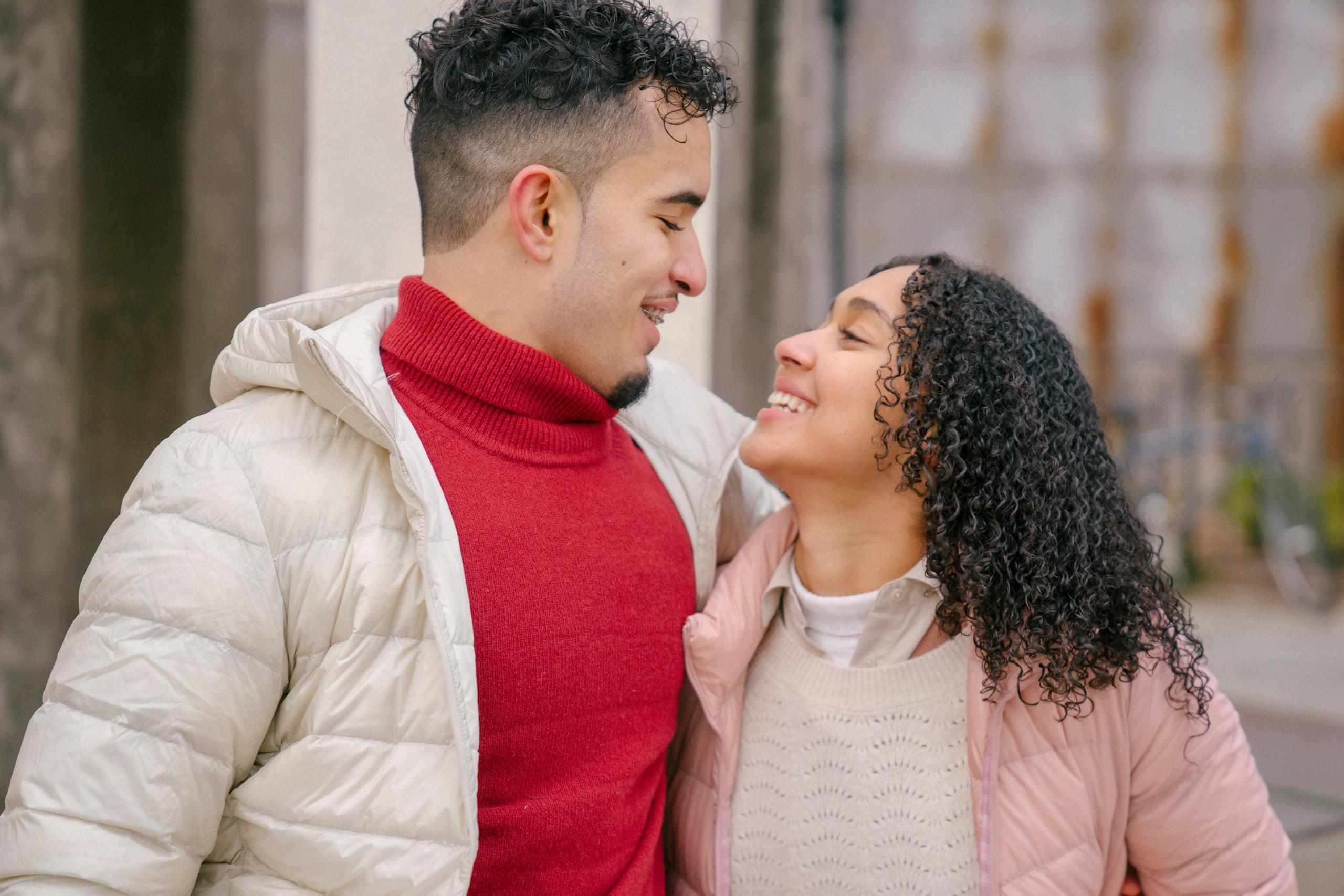 Cheerful couple sharing a joyful moment outdoors in the city. Perfect shot of romance and happiness.