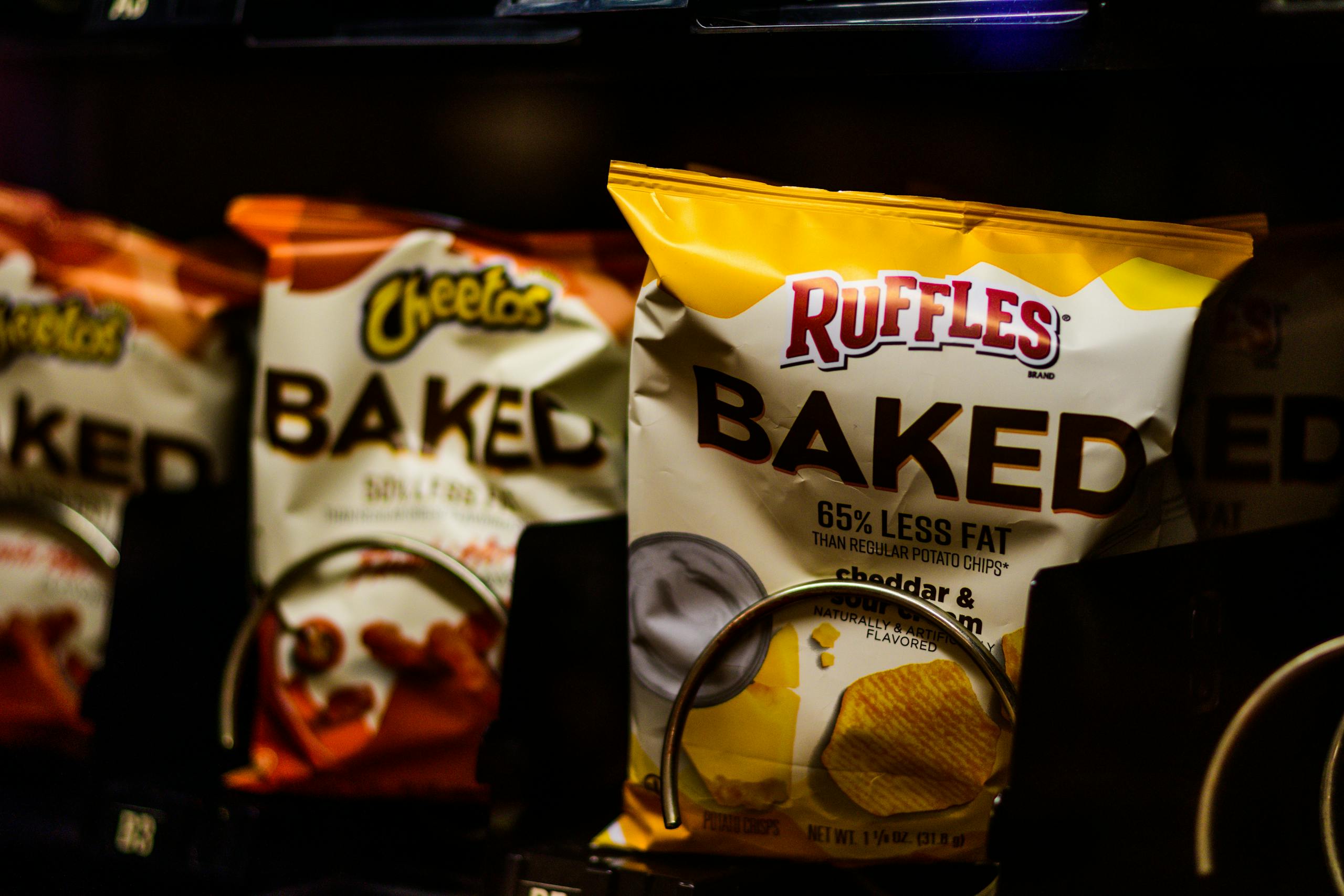 Close-up of a vending machine showcasing baked snacks like chips for a tasty treat.