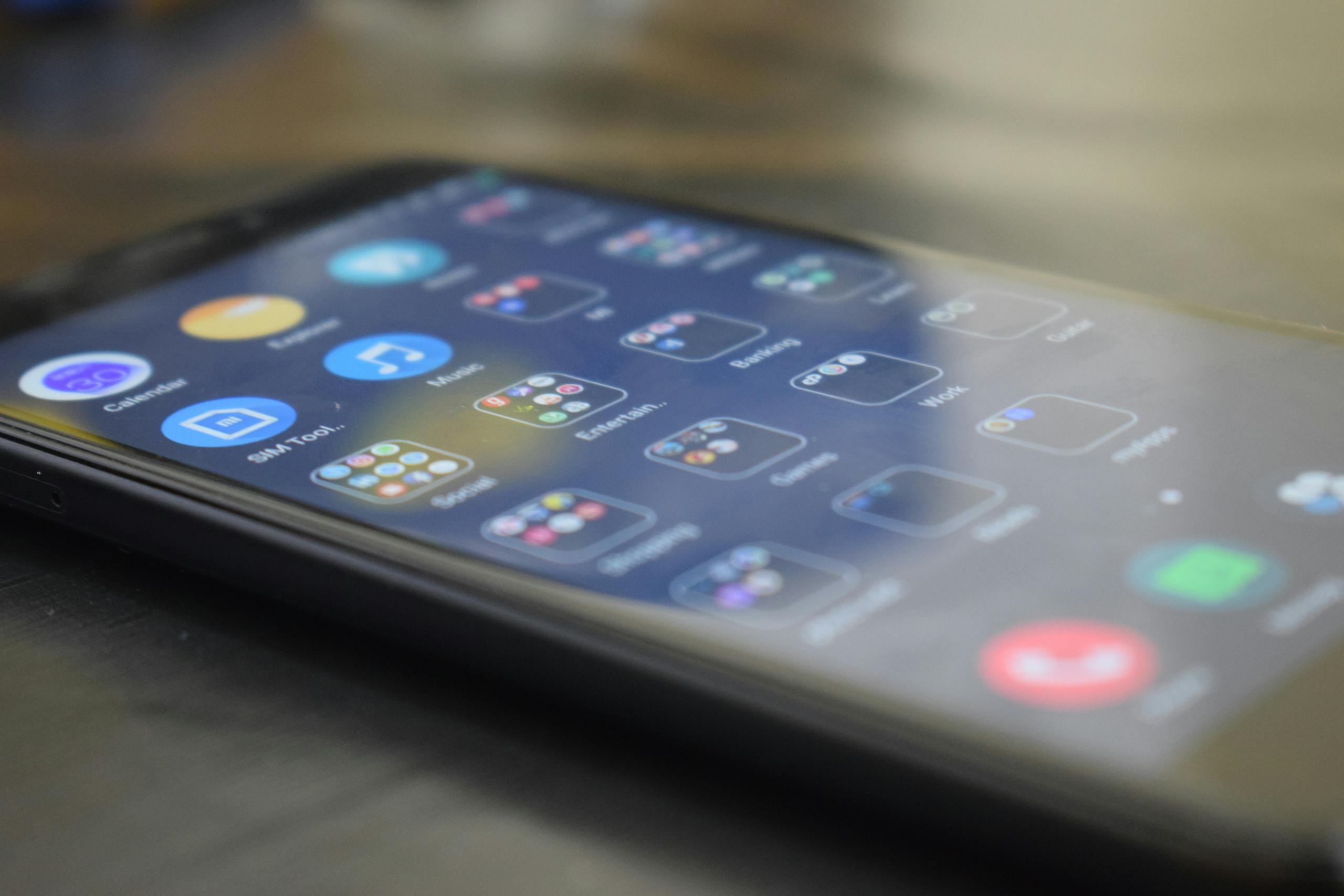 Close-up shot of a smartphone screen showing various app icons, indicating digital technology use.