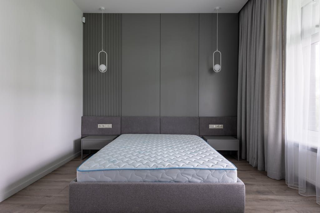 Stop Believing These 10 Sleep Myths, They’re Wrecking Your Rest 1 Comfortable bed with convenient modern mattress in contemporary interior of spacious gray bedroom